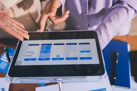 Close up ux developer and ui designer brainstorming about mobile app interf.. Stock Photos