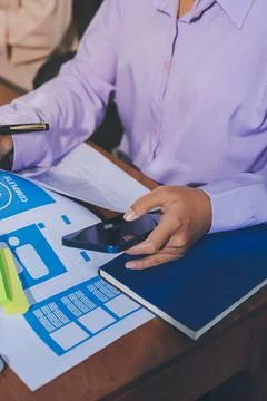 Close up ux developer and ui designer brainstorming about mobile app interf.. Stock Photos