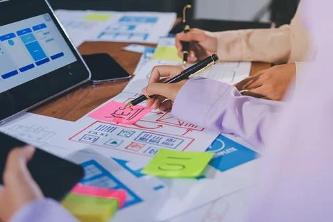 Close up ux developer and ui designer brainstorming about mobile app interf.. Stock Photos