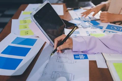 Close up ux developer and ui designer brainstorming about mobile app interf.. Stock Photos