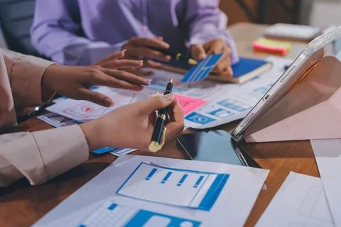 Close up ux developer and ui designer brainstorming about mobile app interf.. Stock Photos