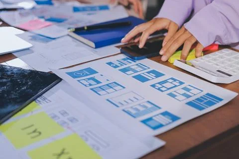 Close up ux developer and ui designer brainstorming about mobile app interf.. Stock Photos
