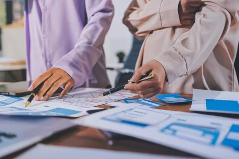 Close up ux developer and ui designer brainstorming about mobile app interf.. Stock Photos