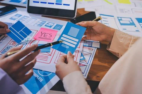 Close up ux developer and ui designer brainstorming about mobile app interf.. Stock Photos