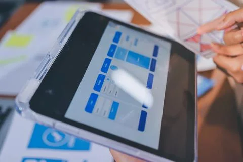 Close up ux developer and ui designer brainstorming about mobile app interf.. Stock Photos