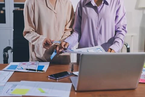Close up ux developer and ui designer brainstorming about mobile app interf.. Stock Photos