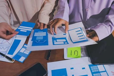 Close up ux developer and ui designer brainstorming about mobile app interf.. Stock Photos