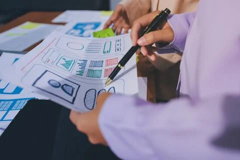 Close up ux developer and ui designer brainstorming about mobile app interf.. Stock Photos