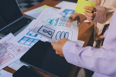 Close up ux developer and ui designer brainstorming about mobile app interf.. Stock Photos