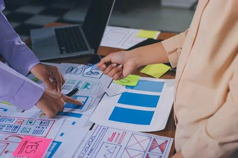 Close up ux developer and ui designer brainstorming about mobile app interf.. Stock Photos