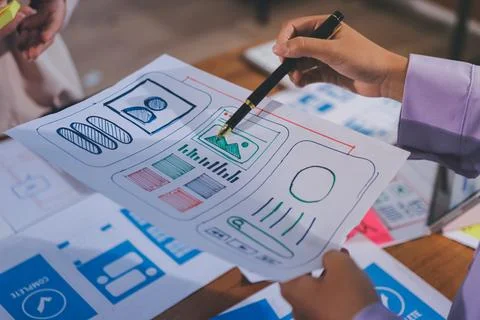 Close up ux developer and ui designer brainstorming about mobile app interf.. Stock Photos