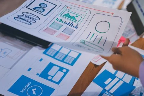 Close up ux developer and ui designer brainstorming about mobile app interf.. Stock Photos