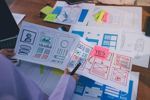 Close up ux developer and ui designer brainstorming about mobile app interf.. Stock Photos