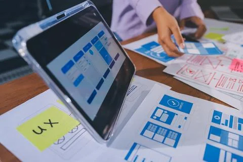 Close up ux developer and ui designer brainstorming about mobile app interf.. Stock Photos