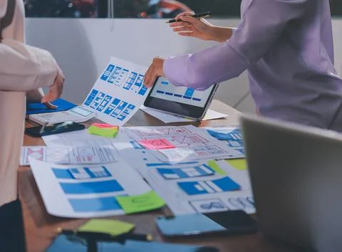 Close up ux developer and ui designer brainstorming about mobile app interf.. Stock Photos