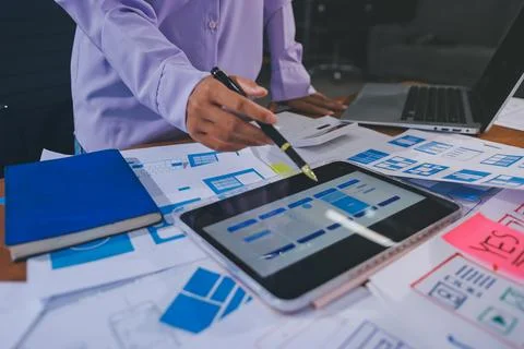 Close up ux developer and ui designer brainstorming about mobile app interf.. Stock Photos