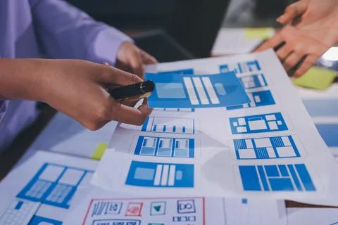 Close up ux developer and ui designer brainstorming about mobile app interf.. Stock Photos