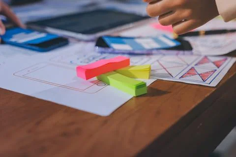Close up ux developer and ui designer brainstorming about mobile app interf.. Stock Photos