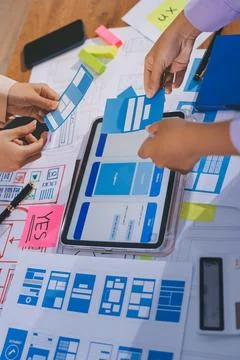 Close up ux developer and ui designer brainstorming about mobile app interf.. Stock Photos
