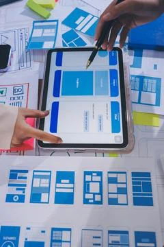 Close up ux developer and ui designer brainstorming about mobile app interf.. Stock Photos