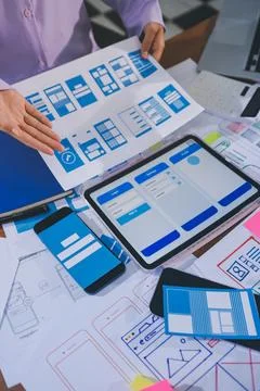 Close up ux developer and ui designer brainstorming about mobile app interf.. Stock Photos