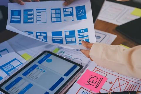 Close up ux developer and ui designer brainstorming about mobile app interf.. Stock Photos