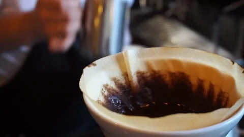 Close up of V60 coffee maker dripping barista in the background Video stock 85616140