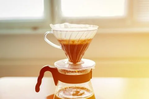 Close-up of a v60 decanter, alternative method of brewing coffee. Air bubbles on Stock Photos
