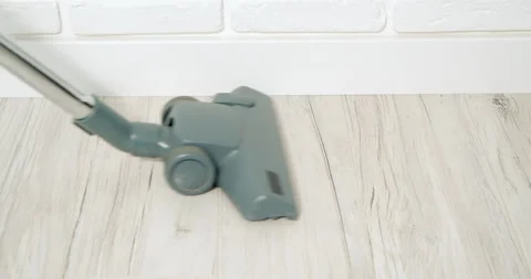 Close-up of a vacuum cleaner brush cleaning dust and hair from the floor. Stock Footage 157648236