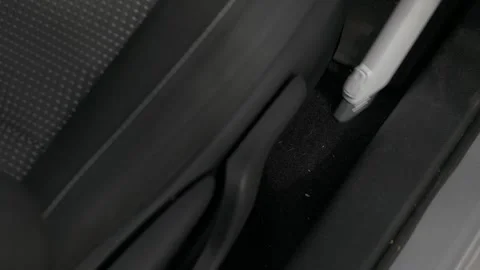 Close-up of the vacuum cleaner that cleans the carpet between the seats of the Stock Footage 240327395
