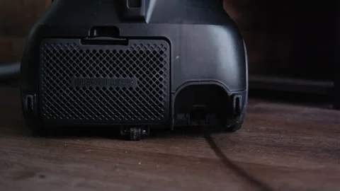 Close-Up of Vacuum Cleaner Cord Automatically Rewinding Stock Footage 317973158