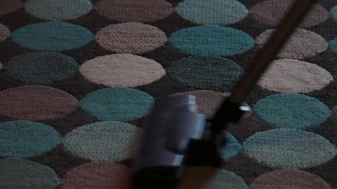 Close-up, a vacuum cleaner is passed on a carpet sucking up dirt Stock Footage 127046867