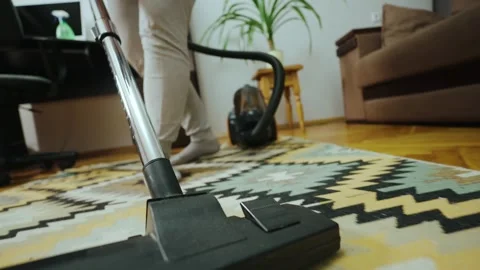 Close-up of a vacuum cleaner running on a carpet in a room. Stock Footage 243129638