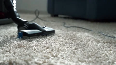 Close up of vacuum cleaner vacuuming carpet Stock Footage 196597366