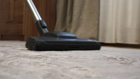Close up of vacuum cleaner vacuuming carpet in modern apartment. Woman to keep Stock Footage 227722280
