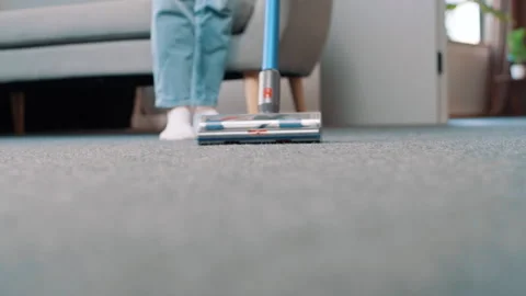 Close up of vacuum cleaner vacuuming carpet in modern apartment Video stock 248002133