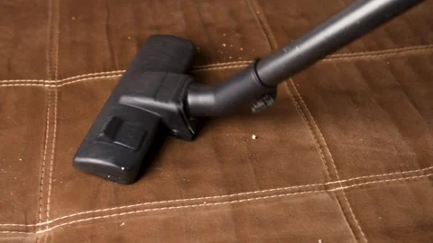 Close up of vacuum cleaner vacuuming sofa Stock Footage 266246350