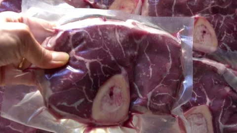 Close-up of vacuum-sealed packaging organic beef (osso buco) Stock Footage 265784027
