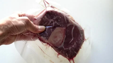 Close-up of vacuum-sealed packaging organic beef (osso buco) Stock Footage 265784034