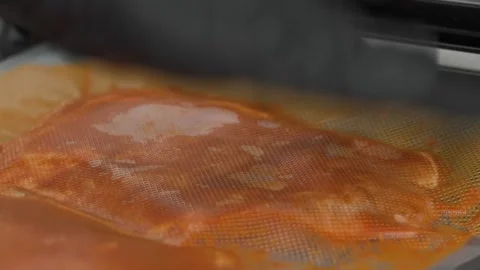 Close-up of vacuum sealing marinated meat in a plastic bag for sous-vide cooking Stock Footage 331633666