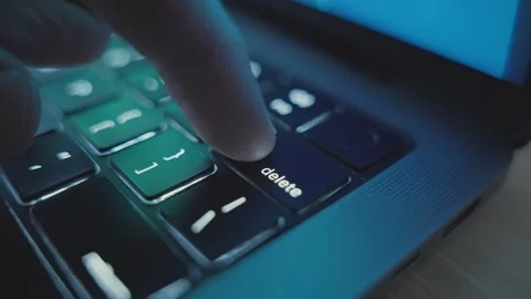 Close up of various clicks on Delete key or button on laptop keyboard at night Stock Footage 340917825