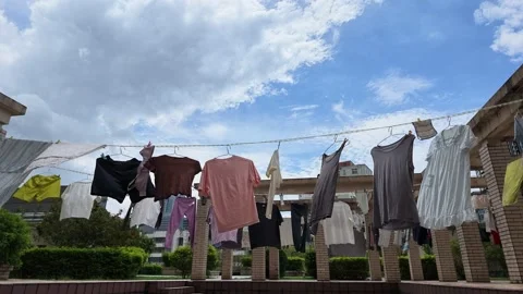 Close Up Of Various Clothes Drying And Blowing In Wind On Balcony Vidéo 343372608