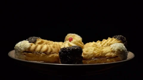 Close-up of various cookies in rotation. Black background. Stock Footage 101407690