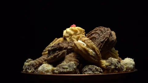 Close-up of various cookies in rotation. Black background. Stock Footage 101409366