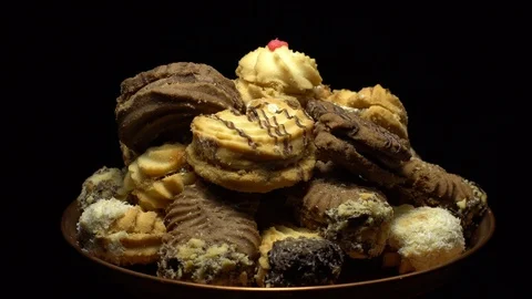 Close-up of various cookies in rotation. Black background. Stock Footage 101409374