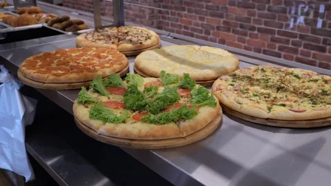 Close-up of various freshly baked pizzas in the restaurant kitchen. Stock Footage 319004214