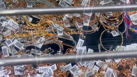 Close up of various gold and silver bracelets on display at a jewelry store. Stock Footage 325449684