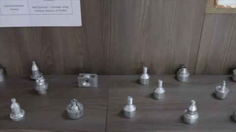 Close Up of Various Lathe Turned Metal Industrial Components Arranged on Wooden Stock Footage 333605435