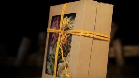 Close-up of various pasta in paper box rotates on black background Stock Footage 75651881
