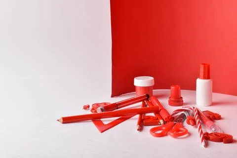 Close-up of various red stationery lying on a red and white background. Back  Stock Photos